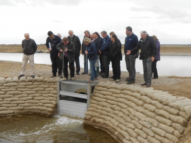 Mark Francois MP opening the sluice to allow water from the River Crouch into a major new part of the RSPB nature reserve at Wallasea Island.