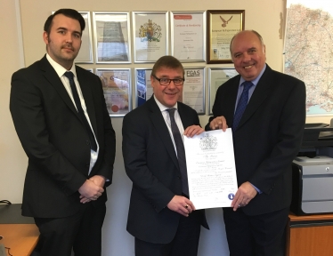 Mark Francois MP with Derek Murton and son David Murton the Directors of European Refrigeration Ltd, showing the Royal Warrant which they were recently awarded for work at Buckingham Palace.