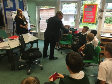 Rayleigh and Wickford MP Mark Francois handing out badges to newly elected School Councillors during his recent visit to Glebe Primary School in Rayleigh.